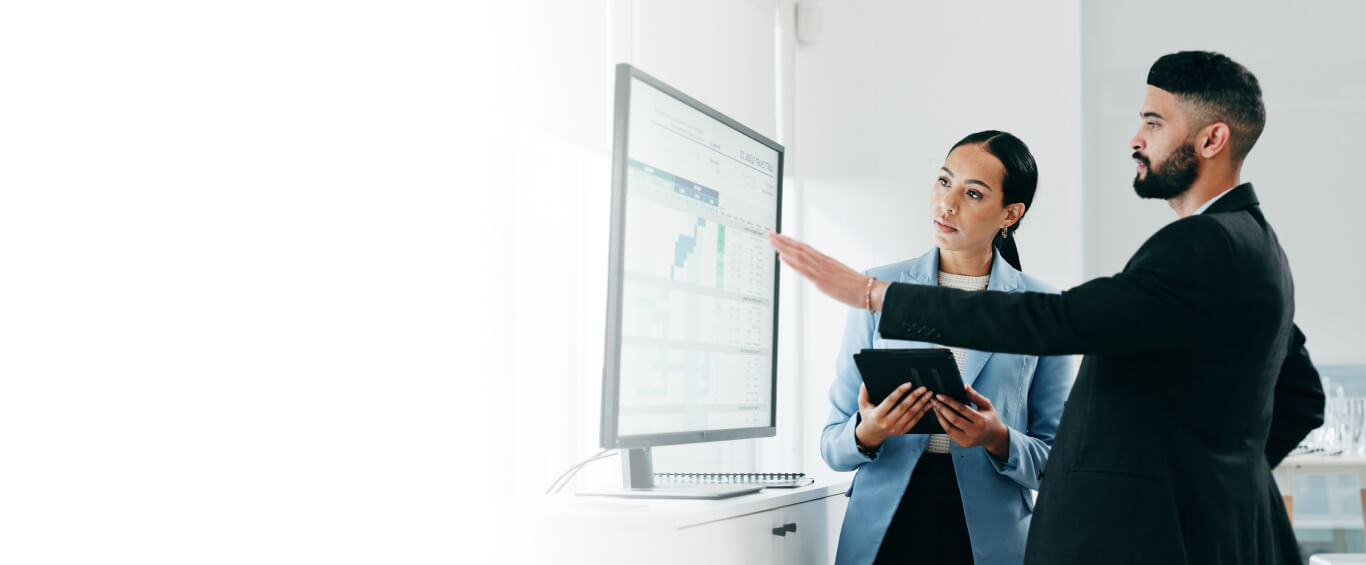 2 people looking at data on screen